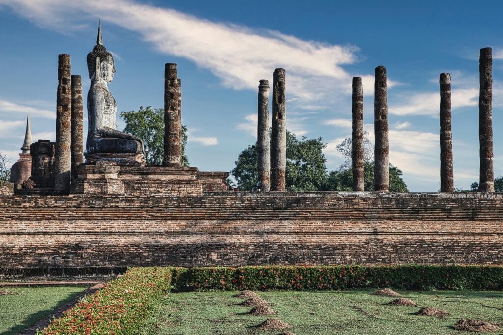 Explore the ancient ruins of a Buddhist temple under a clear blue sky, highlighting historic architecture.